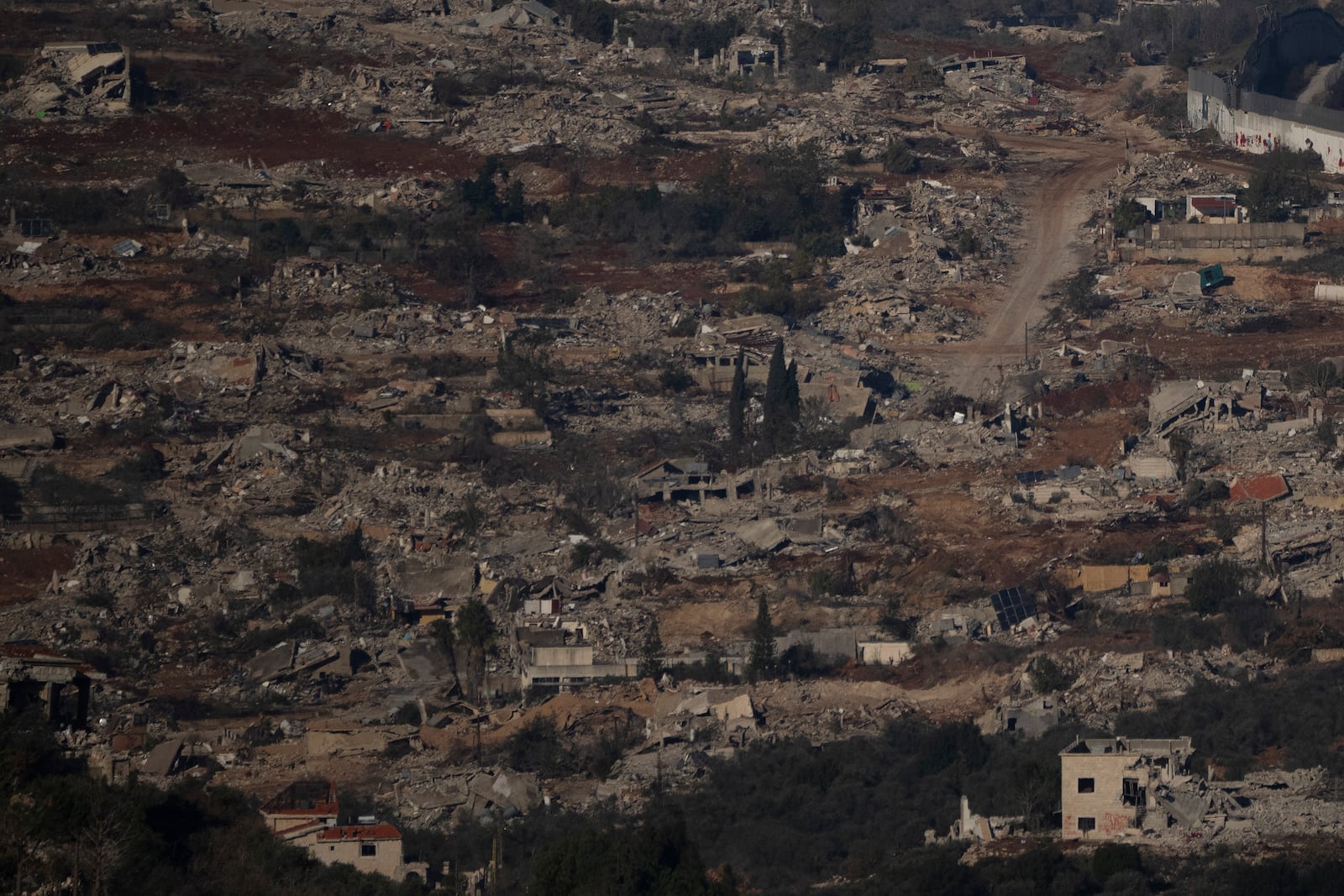 Destroyed buildings in an area of the village of Kfar Kila in southern Lebanon, located next to the Israeli-Lebanese border, as seen from northern Israel, Sunday, Dec. 1, 2024. (AP Photo/Leo Correa)