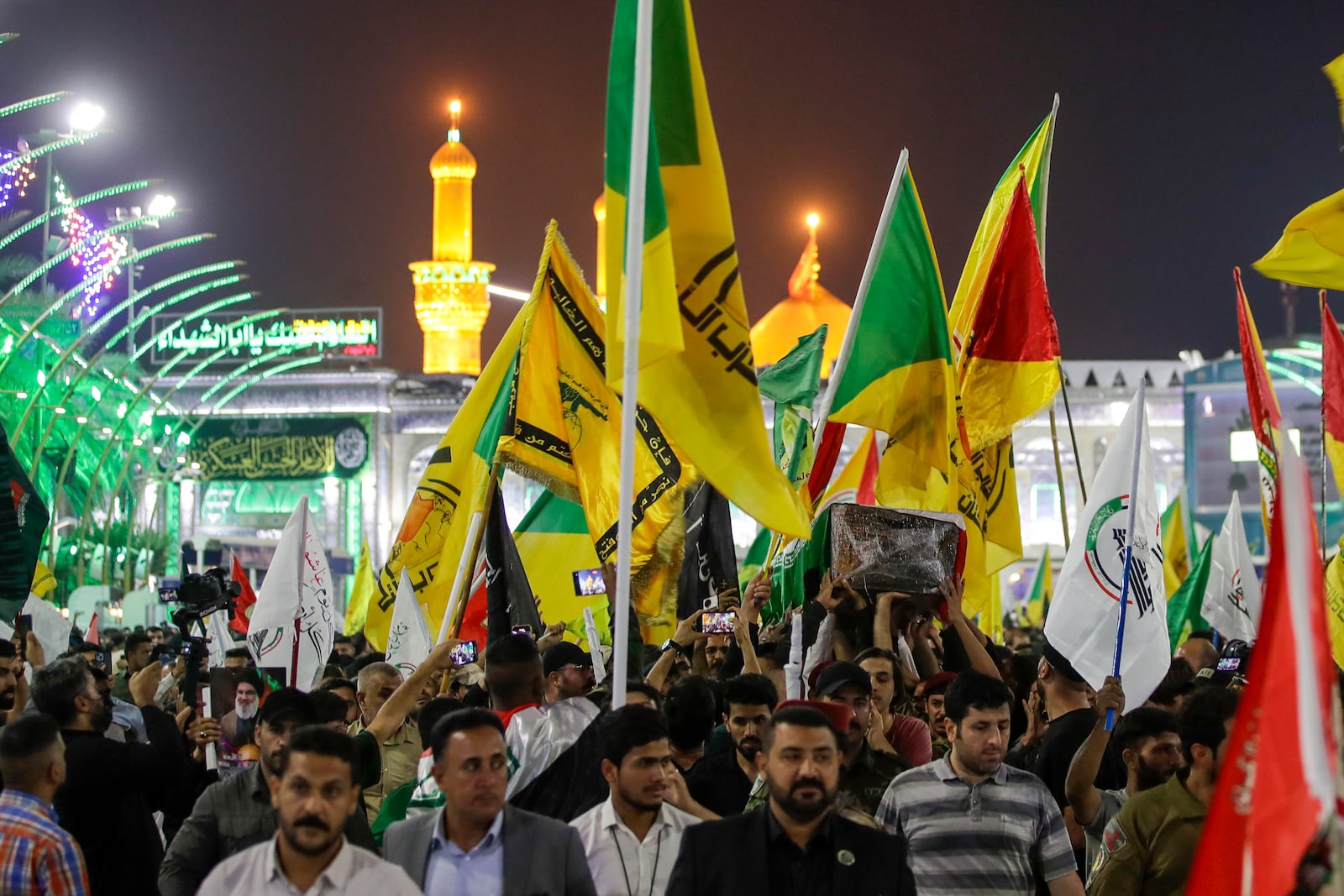 Mourners carry the coffin of Iranian Revolutionary Guards' deputy commander Brigadier Gen. Abbas Nilforushan who died alongside Hezbollah leader Hassan Nasrallah in an Israeli airstrike in Beirut last month during his funeral in Karbala, Iraq, Monday, Oct. 14, 2024. (AP Photo/Anmar Khalil)