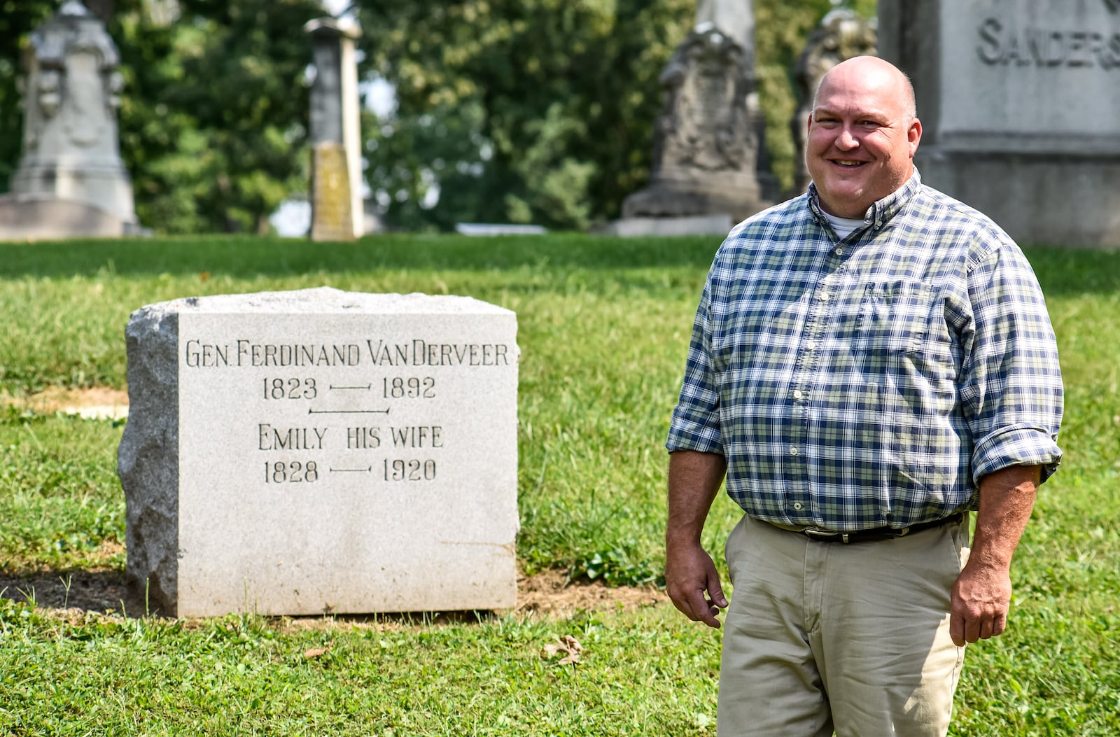 Brian Smith, president of the Butler County Historical Society, stands beside a grave marker for Gen. Ferdinand Van Derveer at Greenwood Cemetery in Hamilton. The Butler County Historical Society is in the process of restoring an American flag brought back by Gen. Van Derveer after flying with the 35th Ohio Infantry Regiment at the Battle of Missionary Ridge during the American Civil War. NICK GRAHAM / STAFF