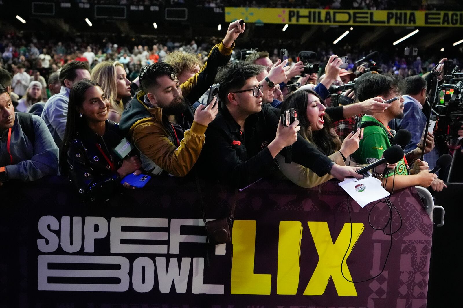 Media gathers during Super Bowl 59 Opening Night, Monday, Feb. 3, 2025, in New Orleans, ahead of the NFL football game between the Philadelphia Eagles and the Kansas City Chiefs Sunday. (AP Photo/Brynn Anderson )