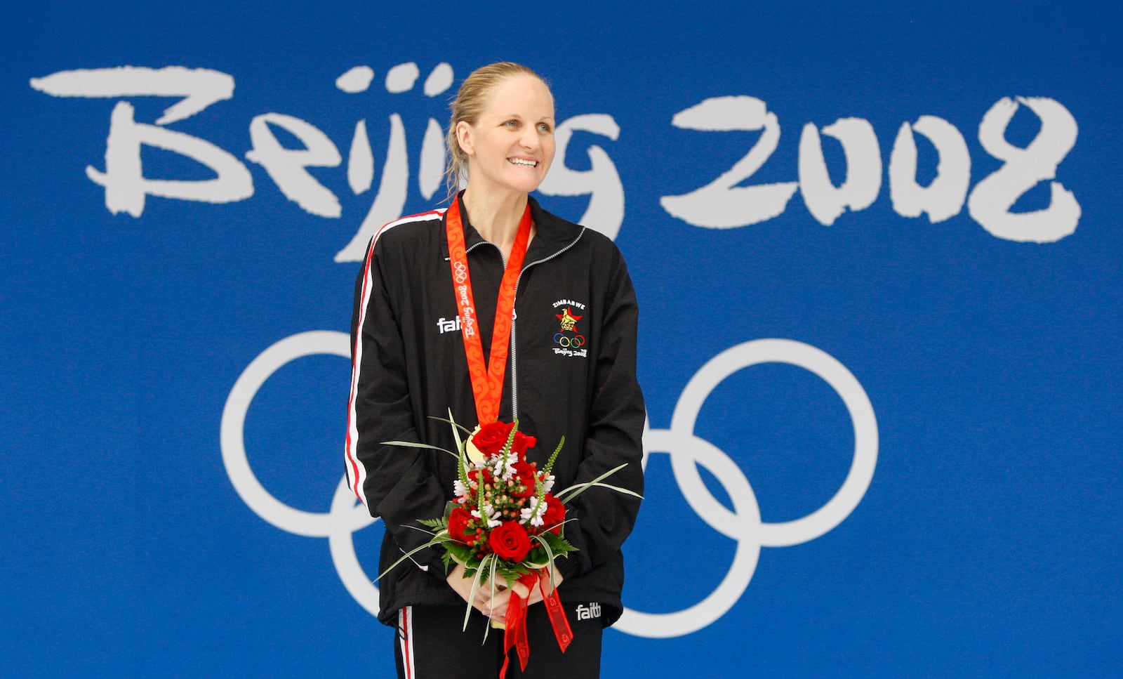 FILE - Zimbabwe's Kirsty Coventry smiles after receiving her gold medal after the women's 200-meter backstroke final during the swimming competitions in the National Aquatics Center at the Beijing 2008 Olympics in Beijing, Saturday, Aug. 16, 2008. (AP Photo/Mark Baker, File)