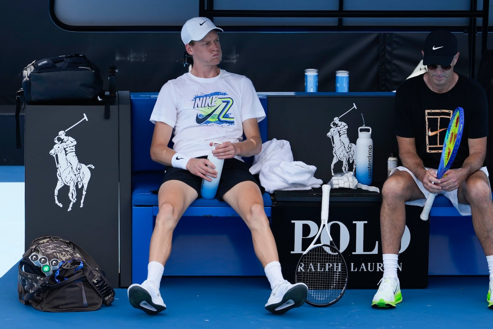 Italy's Jannik Sinner takes a break during a practice session ahead of the Australian Open tennis championship in Melbourne, Australia, Friday, Jan. 10, 2025. (AP Photo/Manish Swarup)