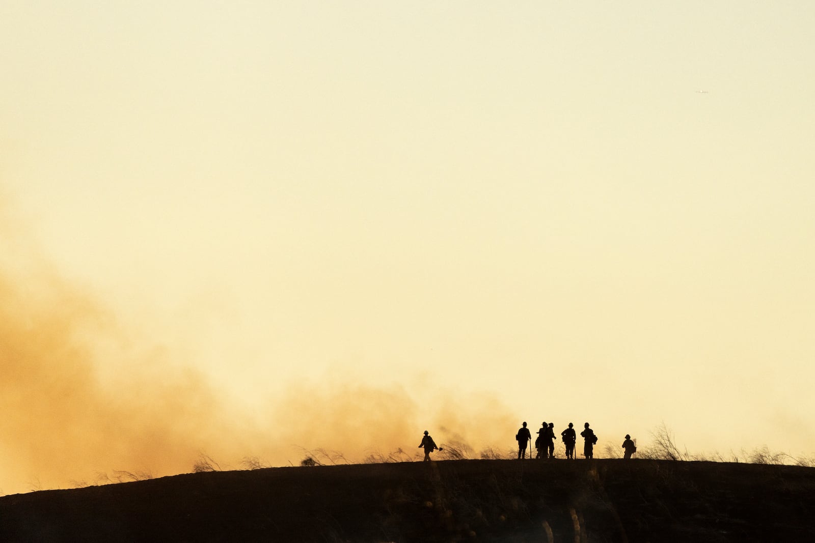 Firefighters monitor hot spots after the Kenneth Fire burnt through hills in the West Hills section of Los Angeles, Thursday, Jan. 9, 2025. (AP Photo/Etienne Laurent)