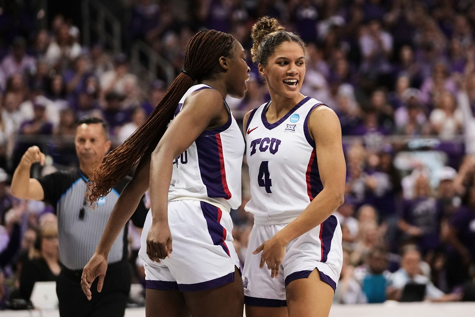 TCU's Agnes Emma-Nnopu, left, and Donovyn Hunter (4) celebrate in the second half against Louisville in the second round of the NCAA college basketball tournament in Fort Worth, Texas, Sunday, March 23, 2025. (AP Photo/Tony Gutierrez)