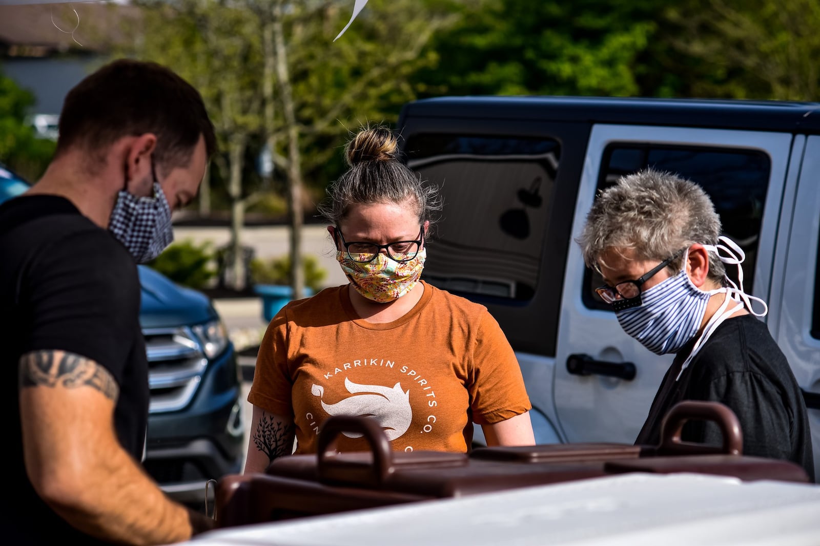 Matt Allen, left, Jamie Murzynowski, middle, and Lynnette Witsken wear masks and gloves as they prepare orders at Cozy’s restaurant Tuesday, April 28, 2020 on Cincinnati Dayton Road in Liberty Township. Cozy’s is trying something different on Tuesdays and Thursdays and offering a drive-up service that will vary by week. Tuesday’s offering was a grill out theme with burgers, hotdogs and more available. They also had margaritas to-go for sale. Cozy’s offers carry out food on other days of the week. NICK GRAHAM / STAFF