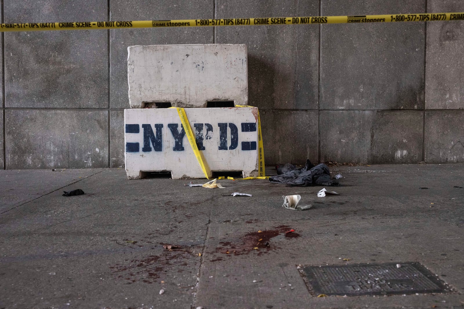 Blood stains the ground at the site of a stabbing spree near the United Nations Headquarters, New York, Monday, Nov. 18, 2024. (AP Photo/Yuki Iwamura)