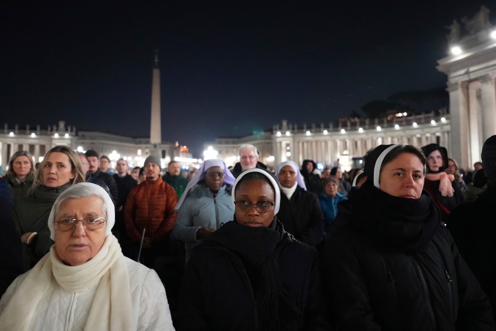 People attend as Cardinal Robert Francis Prevost, Prefect of the Dicastery for Bishops, leads the recitation of the Holy Rosary for Pope Francis' health in St Peter's Square at the Vatican, Monday, March 3, 2025. (AP Photo/Kirsty Wigglesworth)