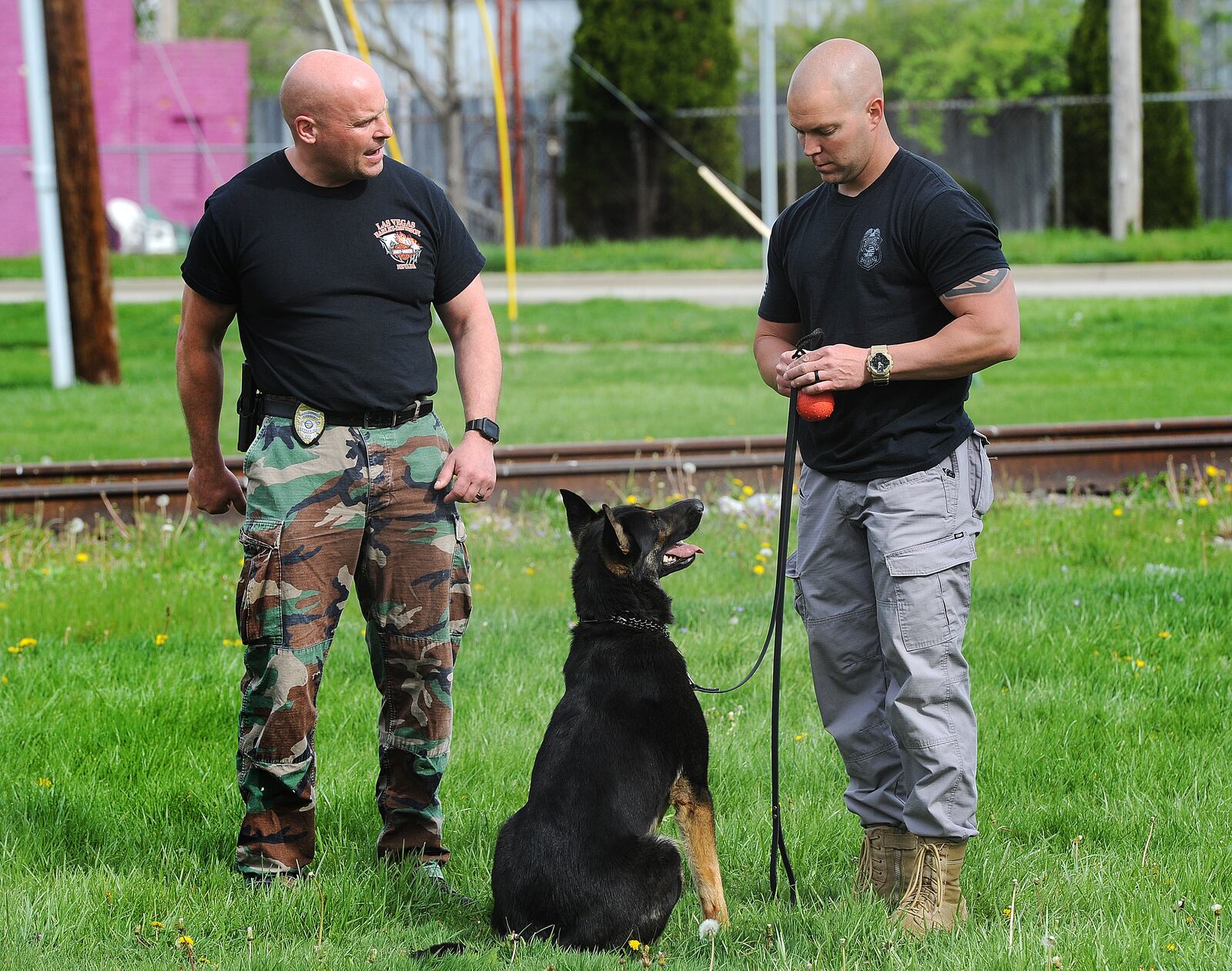 Kettering police Lt. Brad Lambert, left, gives feedback to fellow Kettering police Officer Matt Harper and K-9 Bolt about an obedience exercise that involved firing a handgun with blanks during a training session Thursday in Kettering. Lambert evaluates the handler and K-9 on how they react to the gun shots. Kettering police is training several K-9s in the area for free so that there is a standardized level of training for the dogs and handlers. The 12-week course ends June 30 with an evaluation by the Ohio Peace Officers Training Academy. If they pass the evaluation, the dog will receive state K-9 certification. MARSHALL GORBY\STAFF