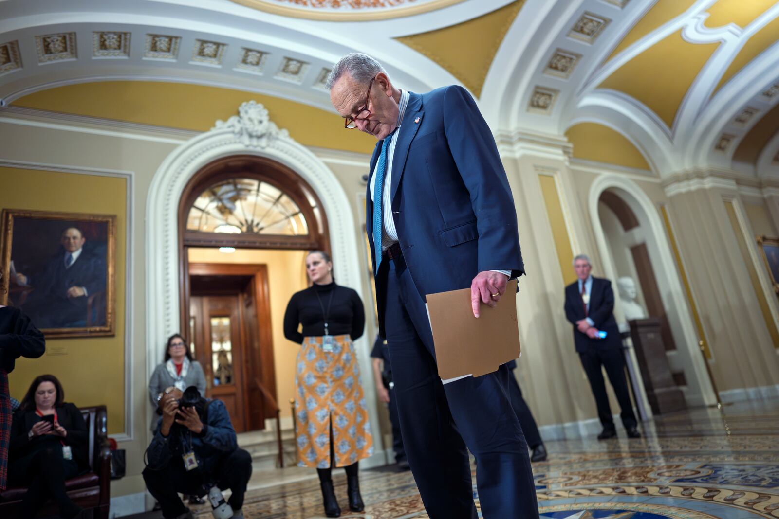 Senate Majority Leader Chuck Schumer, D-N.Y., pauses with his notes before updating reporters on efforts to fund the government before the midnight Friday deadline, at the Capitol in Washington, Tuesday, Dec. 17, 2024. Congressional leaders are nearing the unveiling of an agreement that will keep the federal government funded through March 14 and provide more than $100 billion in emergency aid to help states and local communities recover from Hurricanes Helene and Milton, and other natural disasters. (AP Photo/J. Scott Applewhite)