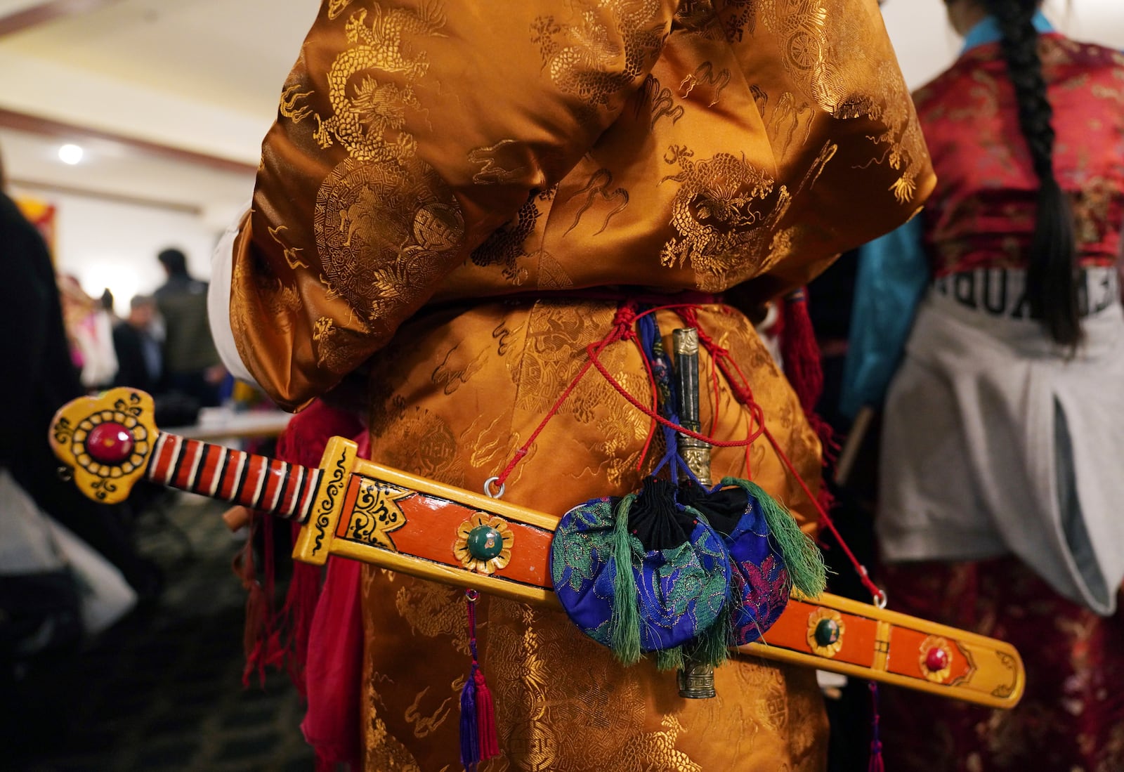 Elders dress in traditional clothing to perform a ceremonial Tibetan dance to welcome U.S.-born Buddhist lama, Jalue Dorje, to his 18th birthday and enthronement ceremony in Isanti, Minn., on Saturday, Nov. 9, 2024. (AP Photo/Jessie Wardarski)