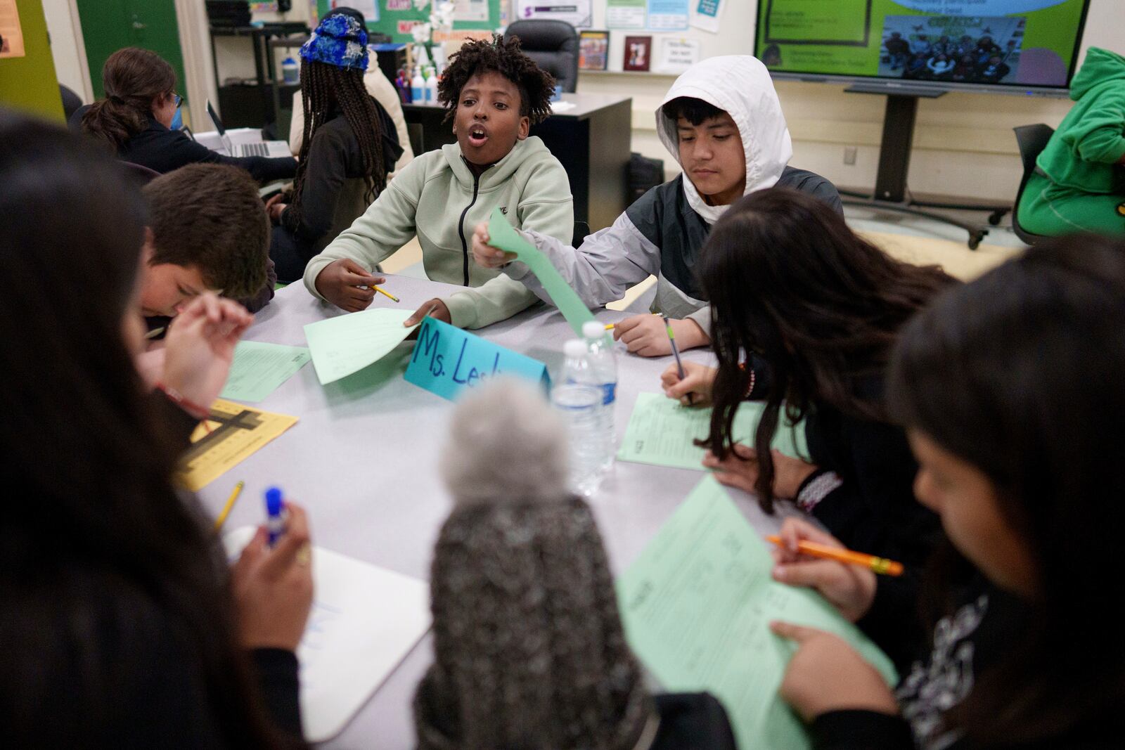 A tutor helps students at Benjamin O. Davis Middle School in Compton, Calif., Thursday, Feb. 6, 2025. (AP Photo/Eric Thayer)