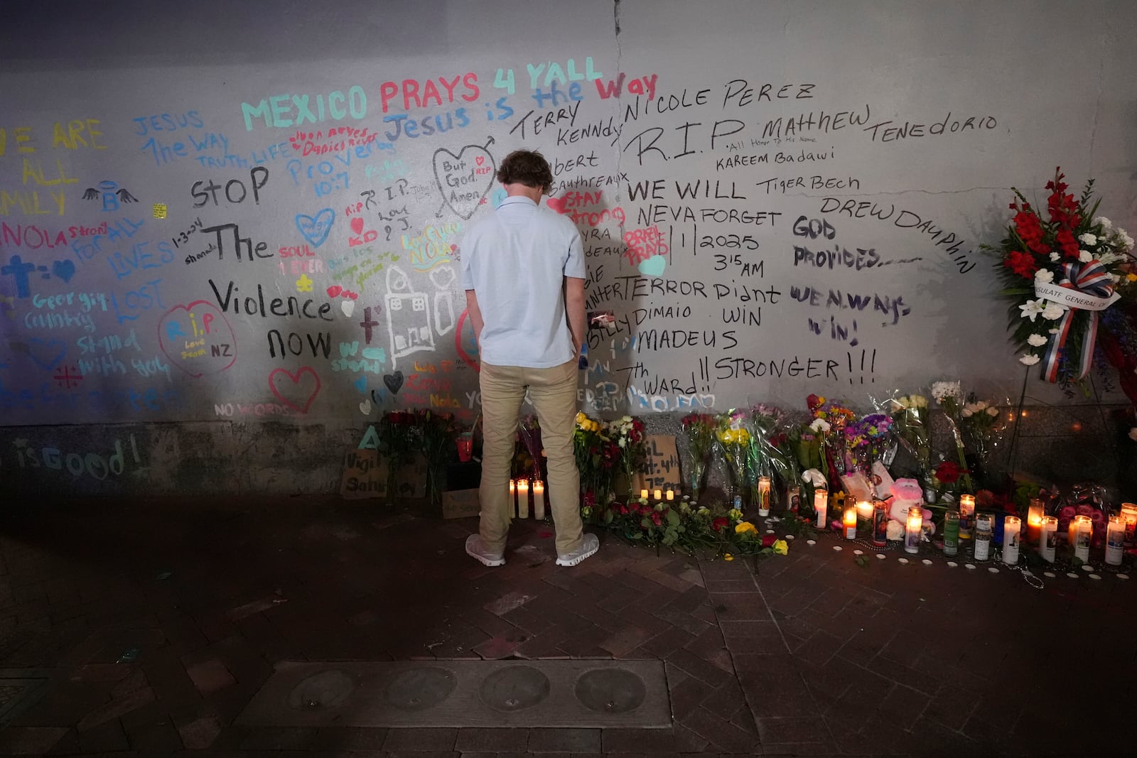 A friend of Kareem Badawi, a victim of the deadly truck attack on New Year's Day in New Orleans, pauses at a memorial for victims after attending his funeral, Friday, Jan. 3, 2025. (AP Photo/Gerald Herbert)