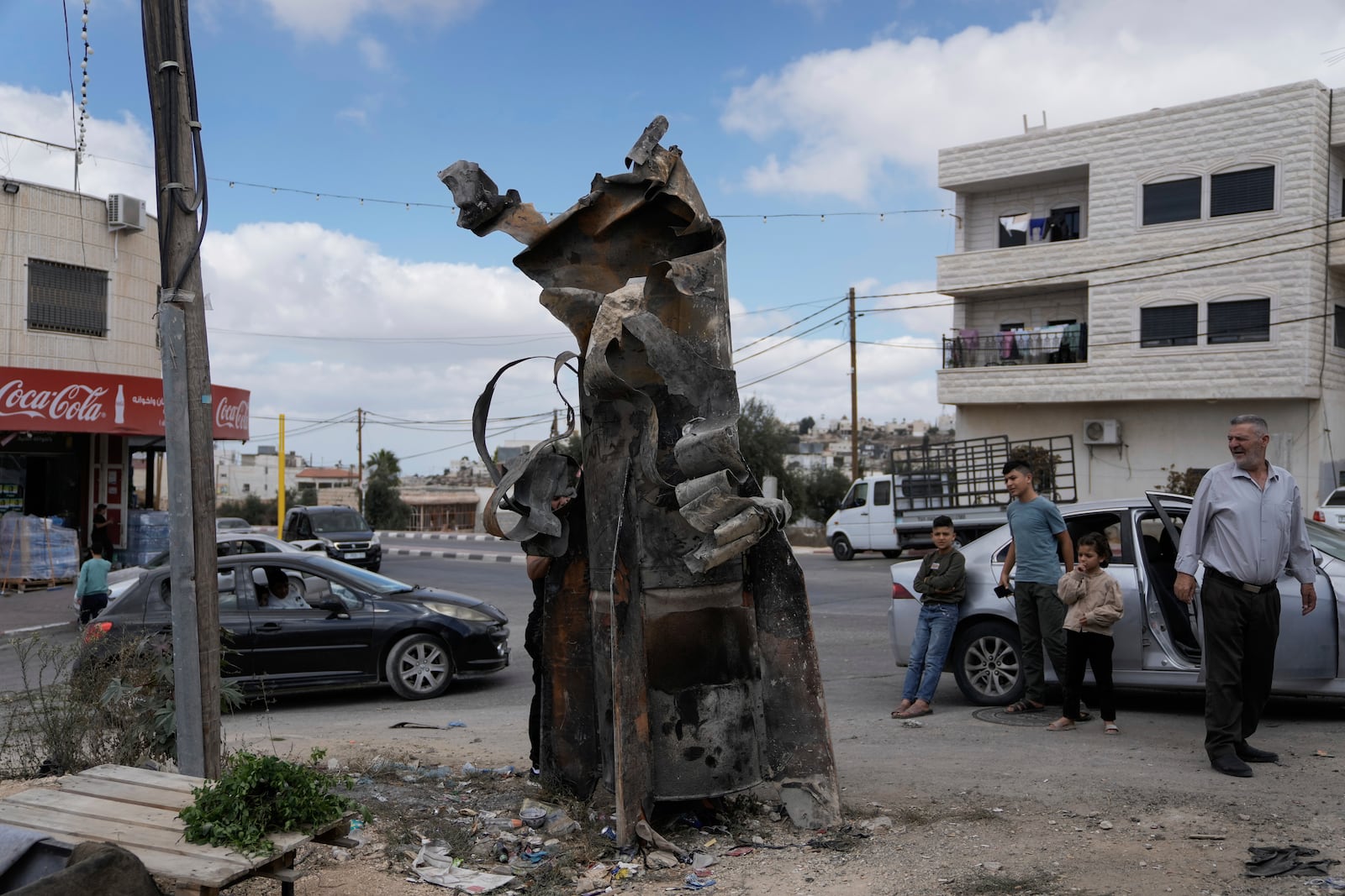 FILE - Palestinians inspect the debris of an Iranian missile intercepted by Israel, in the West Bank city of Hebron, Oct. 2, 2024. (AP Photo/Mahmoud Illean, File)