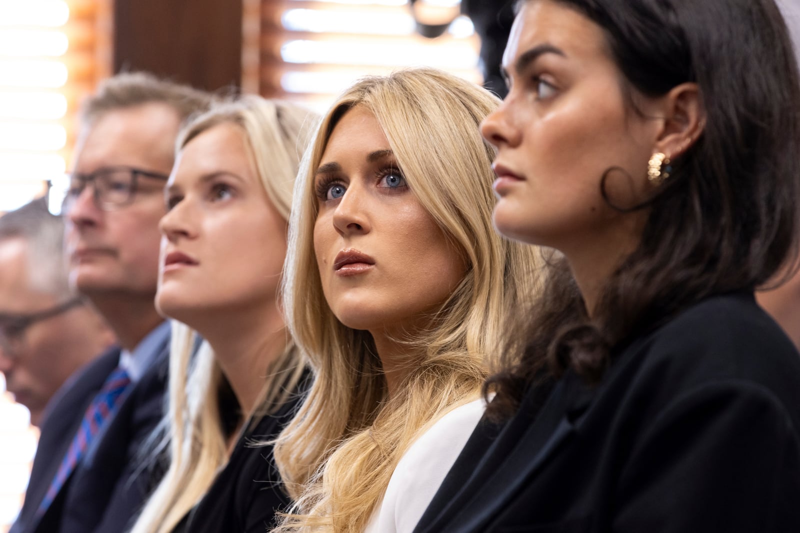 FILE - From third left, former collegiate swimmers Kaitlynn Wheeler, Riley Gaines, and Grace Countie prepare to testify in opposition to transgender athletes in women's sports in front of the state senate's Special Committee on Protecting Women's Sports at the Capitol in Atlanta, Tuesday, Aug. 27, 2024. (Arvin Temkar/Atlanta Journal-Constitution via AP, File)