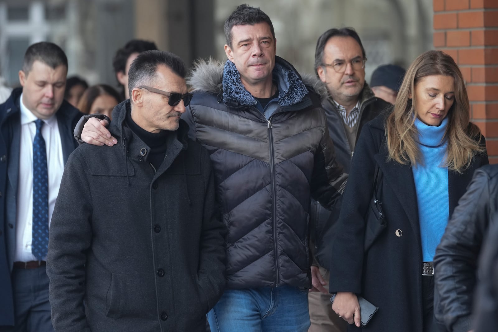 Relatives and friends of victims arrive in the court building prior to a verdict in trial of parents of a boy who killed 9 students and security guard in school shooting in 2023, in Belgrade, Serbia, Monday, Dec. 30, 2024. (AP Photo/Darko Vojinovic)