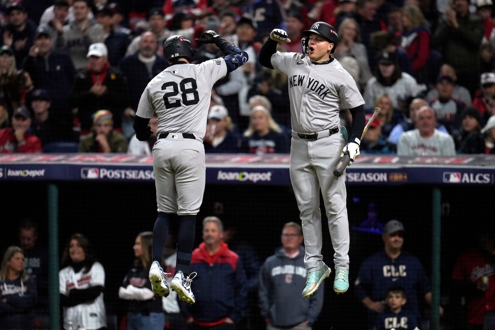 New York Yankees' Austin Wells (28) celebrates with Alex Verdugo after hitting a home run against the Cleveland Guardians during the second inning in Game 4 of the baseball AL Championship Series Friday, Oct. 18, 2024, in Cleveland. (AP Photo/Sue Ogrocki)