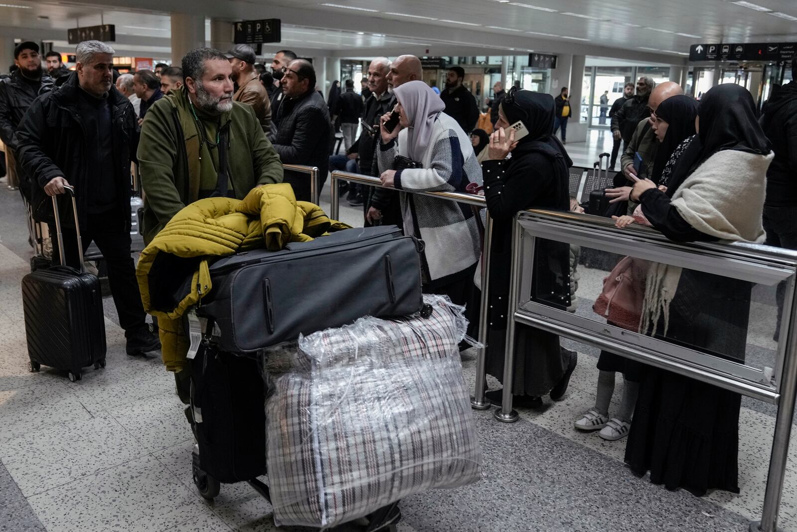 Travelers push their luggage as they arrive at the Rafik Hariri International Airport, in Beirut, Lebanon, Friday, Feb. 21, 2025. (AP Photo/Bilal Hussein)