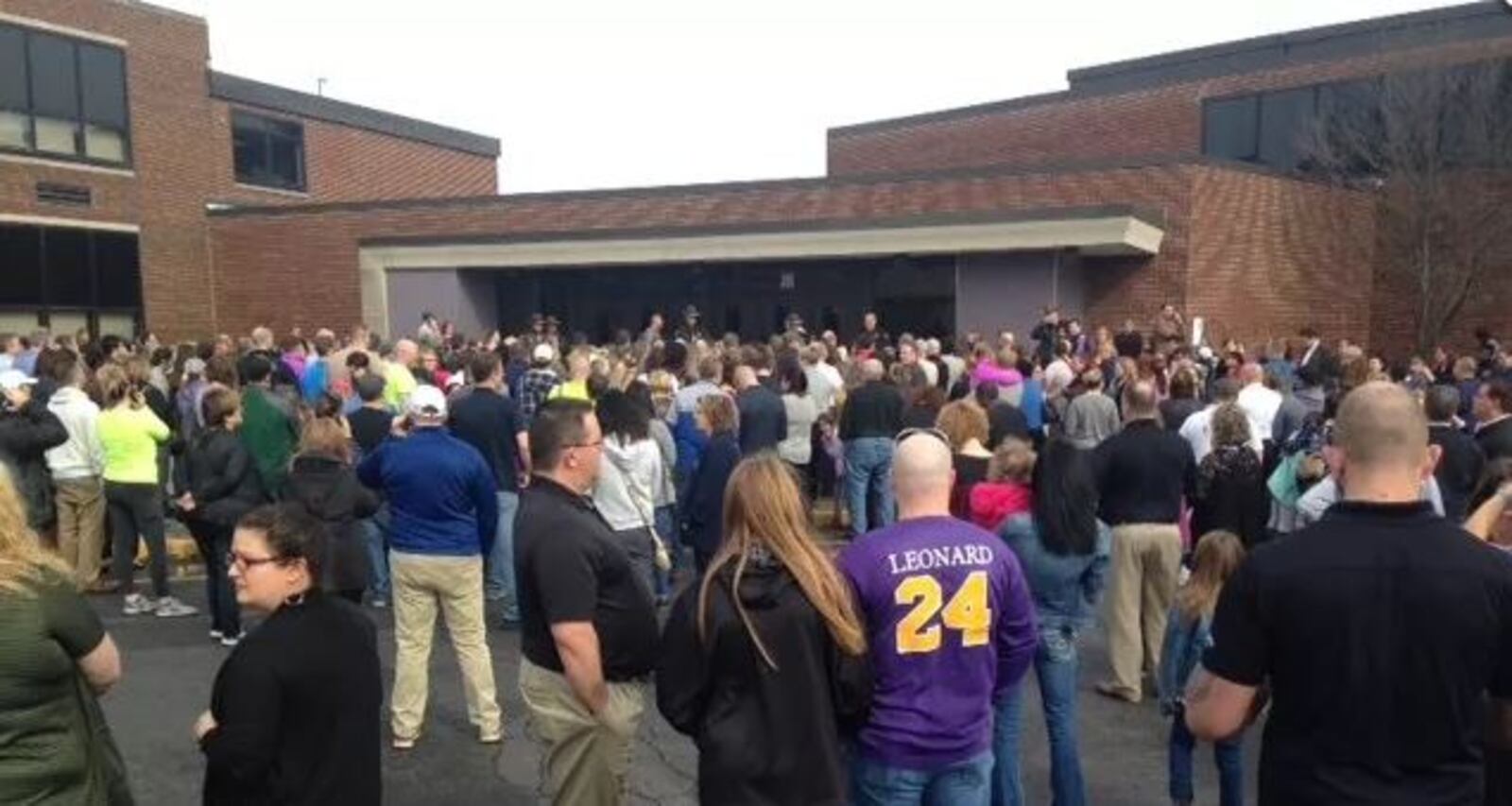 Parents outside Jackson Middle School in Summit County, Ohio, on Feb. 20 after a 13-year-old seventh-grader fatally shot himself inside a bathroom. Police on March 1 revealed the teen had detailed plans on his phone to carry out a school shooting and had 80 rounds of ammunition along with the semiautomatic gun at school.