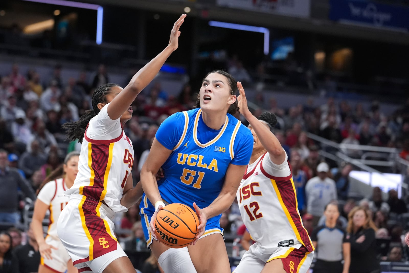 UCLA center Lauren Betts (51) shoots on Southern California center Rayah Marshall (13) during the second half of an NCAA college basketball game in the championship of the Big Ten Conference tournament in Indianapolis, Sunday, March 9, 2025. (AP Photo/Michael Conroy)