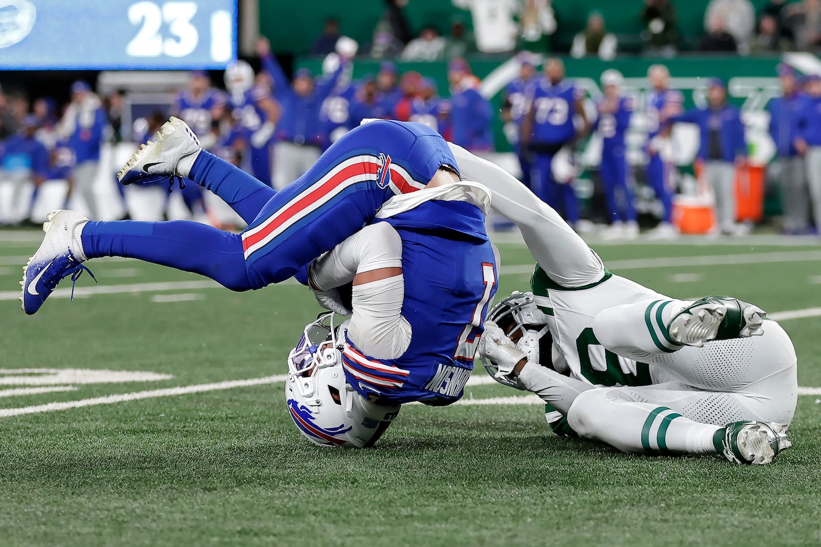 Buffalo Bills cornerback Taron Johnson, left, intercepts a pass intended for New York Jets wide receiver Mike Williams, right, during the second half of an NFL football game in East Rutherford, N.J., Monday, Oct. 14, 2024. (AP Photo/Adam Hunger)