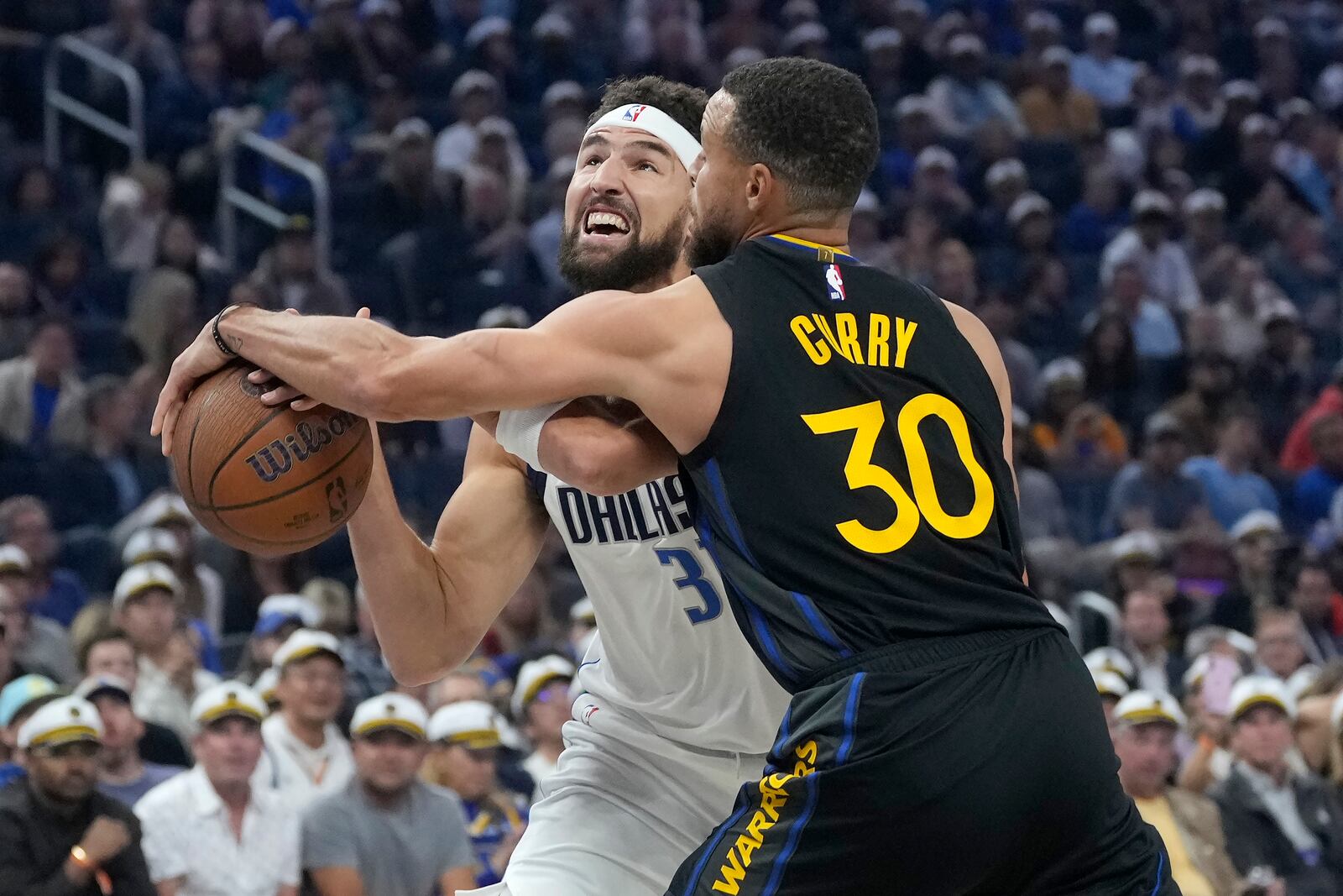 Dallas Mavericks guard Klay Thompson, left, loses the ball while driving to the basket against Golden State Warriors guard Stephen Curry (30) during the first half of an Emirates NBA Cup basketball game in San Francisco, Tuesday, Nov. 12, 2024. (AP Photo/Jeff Chiu)