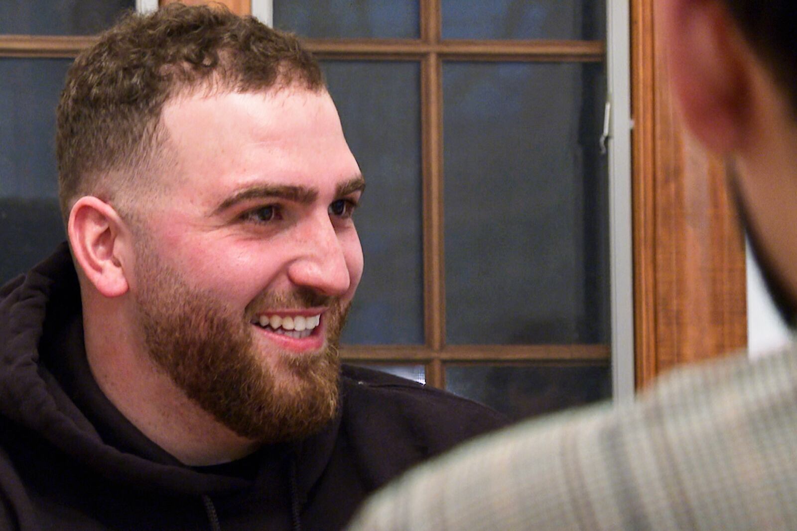 In this image from video, The Helping Handzzz Foundation board member Hussein Sareini smiles during an iftar dinner Friday, March 7, 2025, in Dearborn, Mich. (AP Photo/Mike Householder)