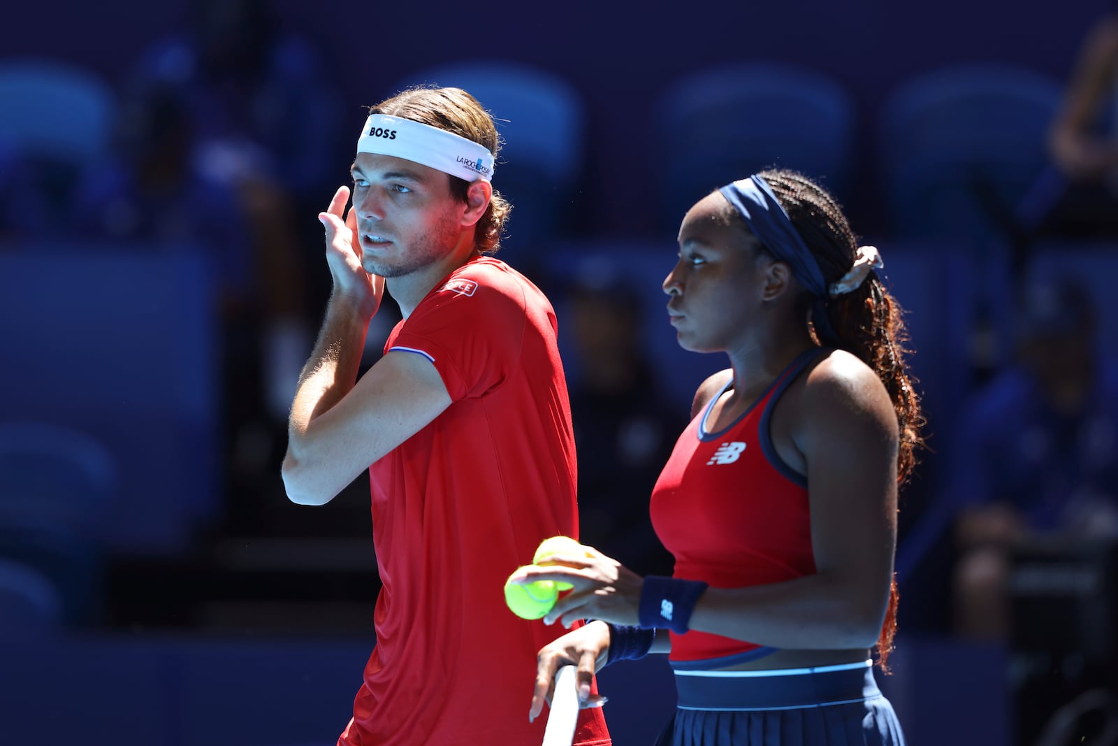 Taylor Fritz and Coco Gauff of the United States talk between point against Petra Marcinko and Ivan Dodig of Croatia during their United Cup mixed doubles tennis match in Perth, Australia, Tuesday, Dec. 31, 2024. (AP Photo/Trevor Collens)