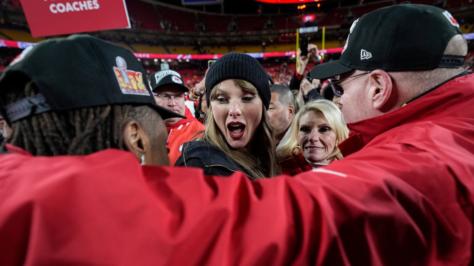 Kansas City Chiefs wide receiver Xavier Worthy, left, and head coach Andy Reid speak with Taylor Swift after the AFC Championship NFL football game against the Buffalo Bills, Sunday, Jan. 26, 2025, in Kansas City, Mo. (AP Photo/Ashley Landis)