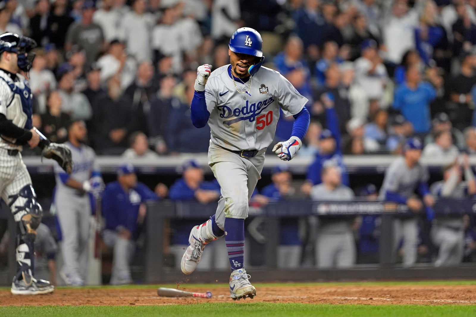 Los Angeles Dodgers' Mookie Betts (50) celebrates after hitting a sacrifice fly against the New York Yankees during the eighth inning in Game 5 of the baseball World Series, Wednesday, Oct. 30, 2024, in New York. (AP Photo/Godofredo A. Vásquez)