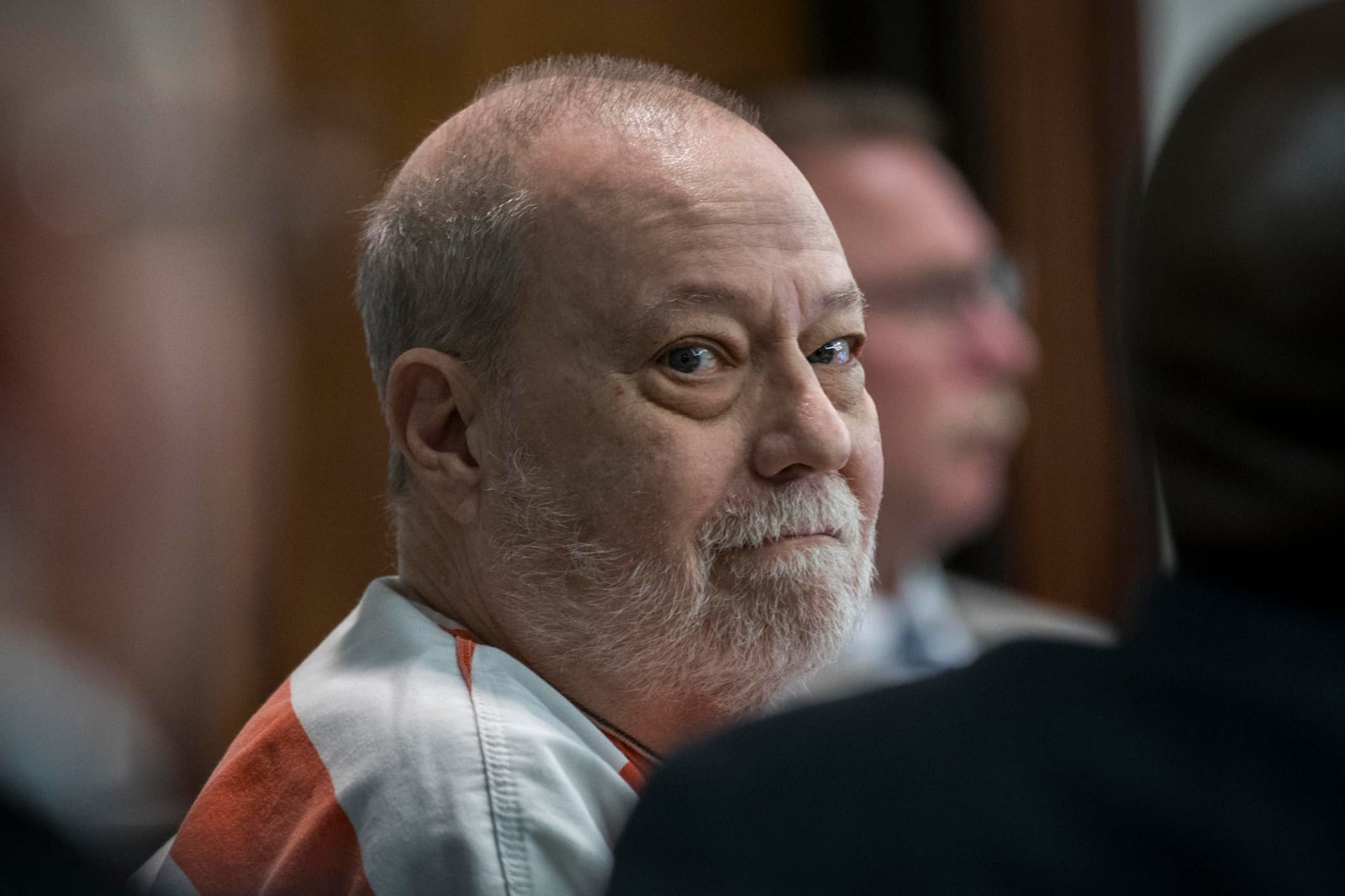 Greg McMichael looks back in the direction of his wife sitting the gallery during a hearing challenging his conviction of killing Ahmaud Arbery in 2020, Thursday, Oct. 24, 2024, in Brunswick, Ga. (AP Photo/Stephen B. Morton)