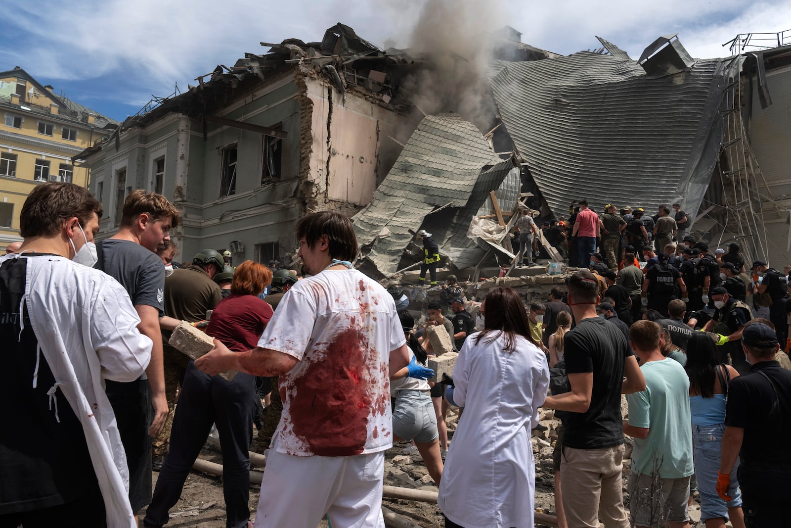 FILE - Rescuers, volunteers and medical workers clean up the rubble and search for victims after a Russian missile hit the country's main children's hospital Okhmadit, in Kyiv, Ukraine, Monday, July 8, 2024. (AP Photo/Efrem Lukatsky, File)