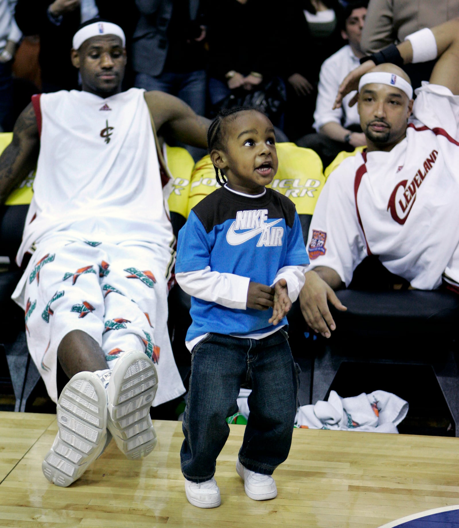 FILE - LeBron James Jr. dances on the court during a time out as his dad Cleveland Cavaliers' LeBron James, left, and Cavaliers' Drew Gooden watch in the fourth quarter of an NBA basketball game, Friday, March 23, 2007, in Cleveland. (AP Photo/Tony Dejak, File)