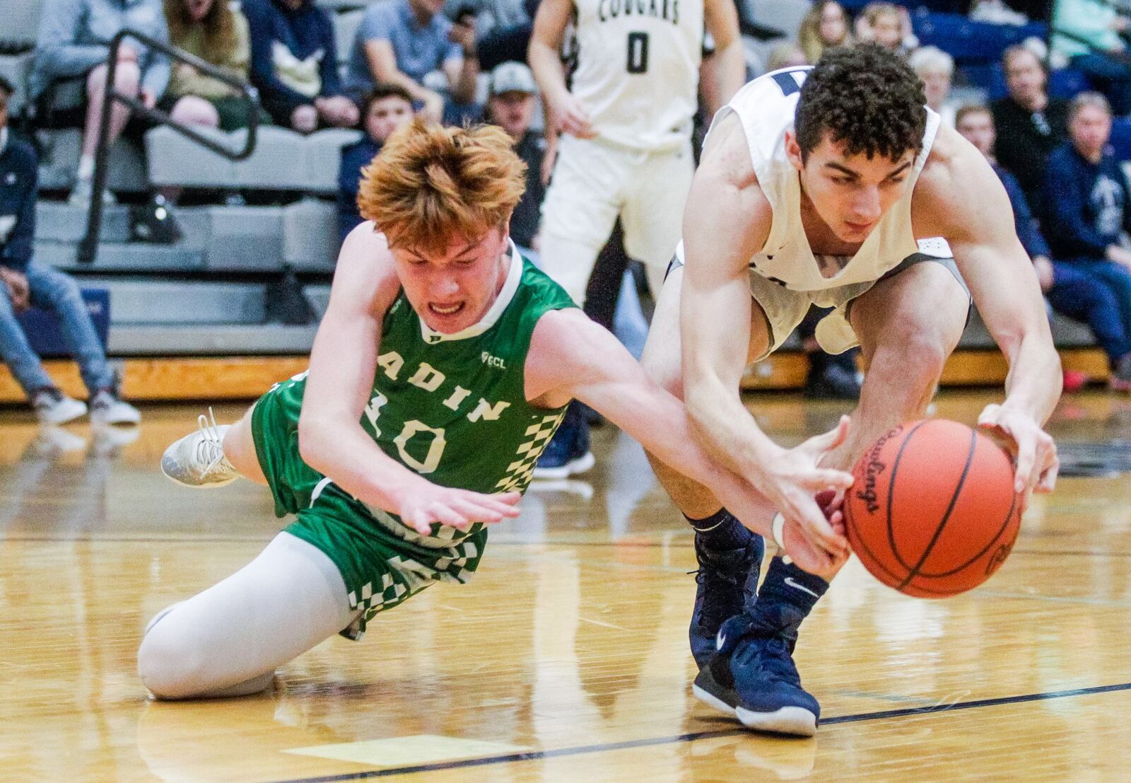 Edgewood’s Logan Loftus (right) and Badin’s Zach Switzer fight for a loose ball during Friday night’s game at Ron Kash Court in St. Clair Township. Badin won 49-46. NICK GRAHAM/STAFF