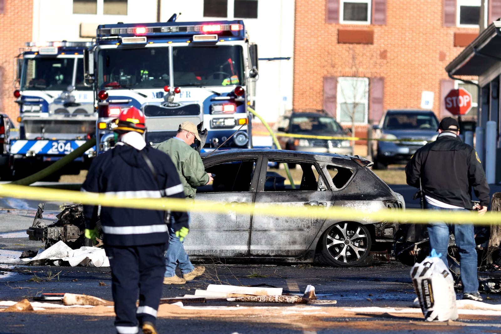 A plane crashed in a parking lot of a Manheim Township, Pa., retirement community, less than a mile south of Lancaster Airport, Sunday, March 9, 2025. (Zach Gleiter/The Patriot-News via AP)