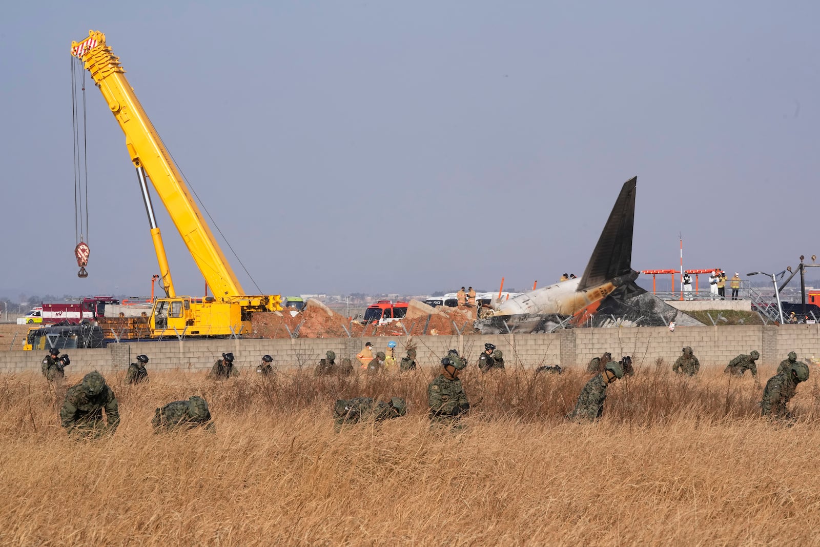 South Korean army soldiers work outside of Muan International Airport in Muan, South Korea, Sunday, Dec. 29, 2024. (AP Photo/Ahn Young-joon)