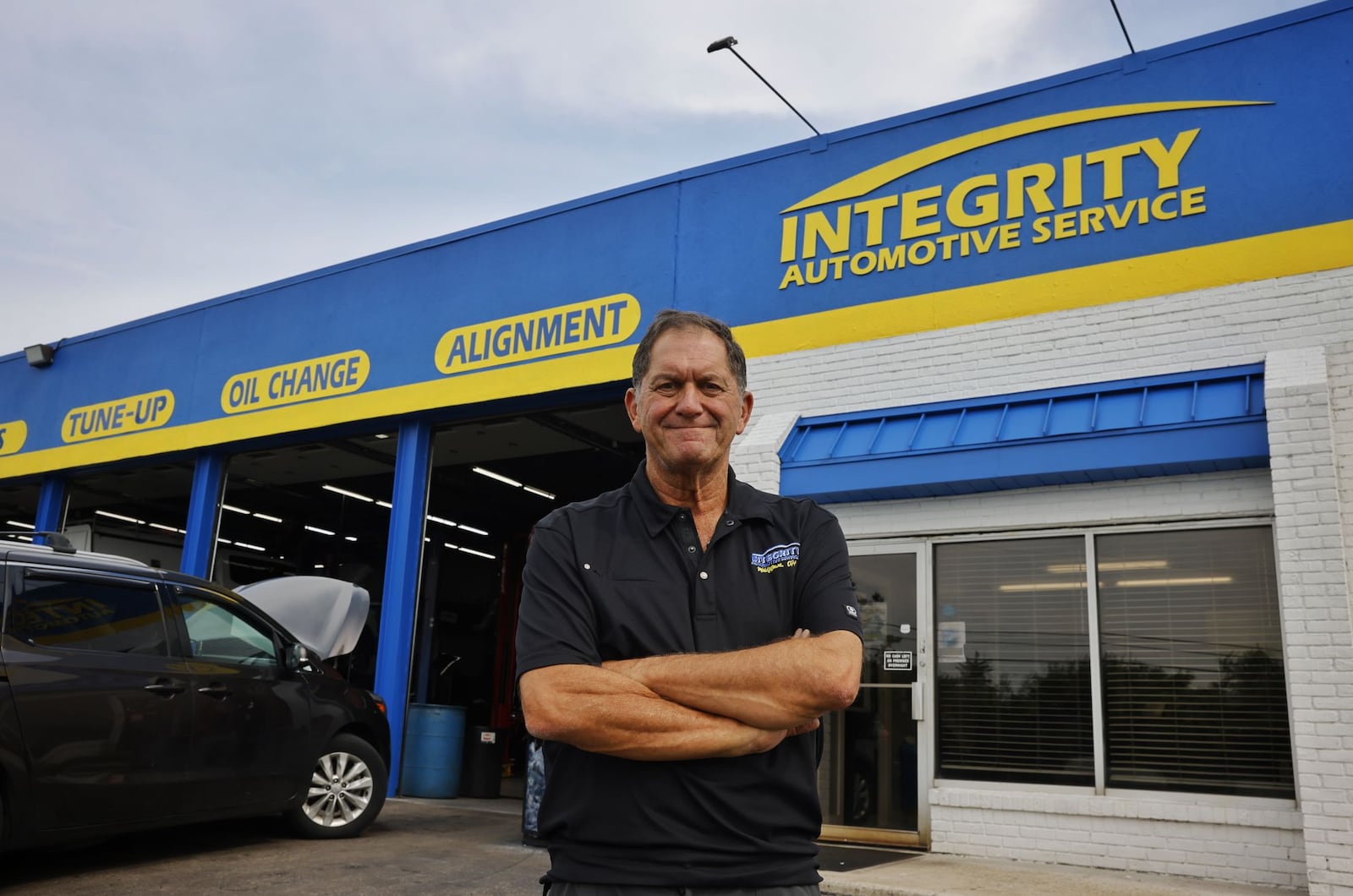 Pete Esposito, owner of Integrity Automotive Service, stands in front of the shop in Middletown. Integrity Automotive is celebrating 25 years in business. NICK GRAHAM/STAFF