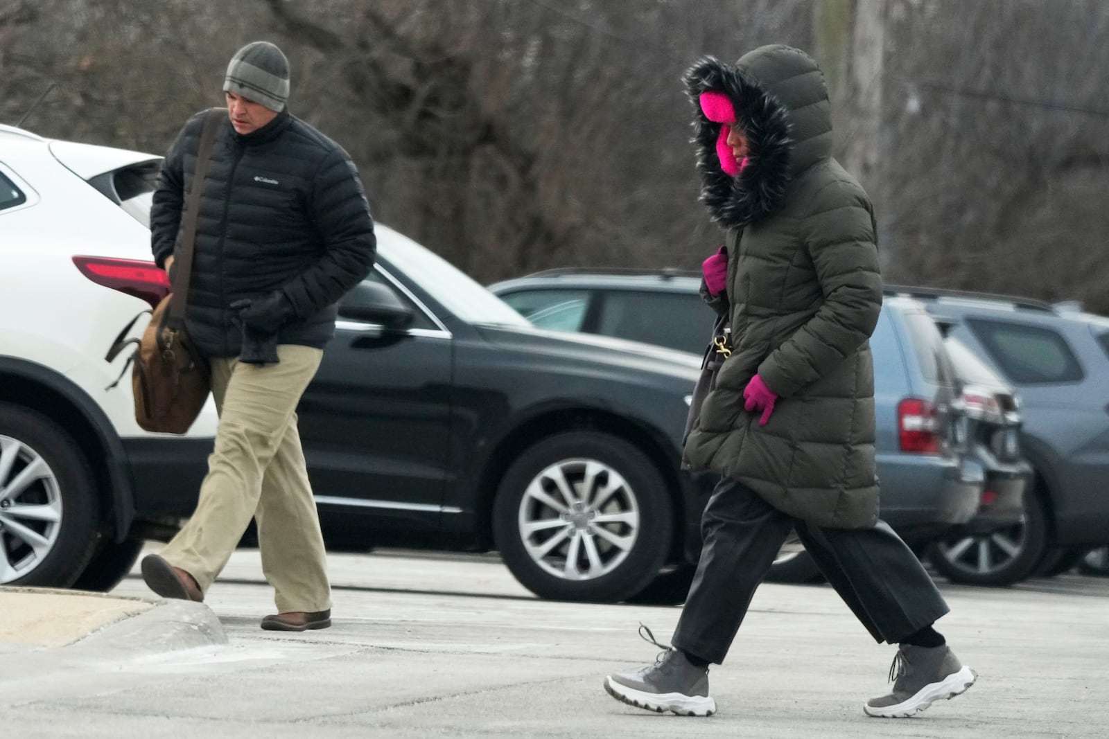 Commuters walk to the train station during cold weather in Northbrook, Ill., Thursday, Dec. 12, 2024. (AP Photo/Nam Y. Huh)