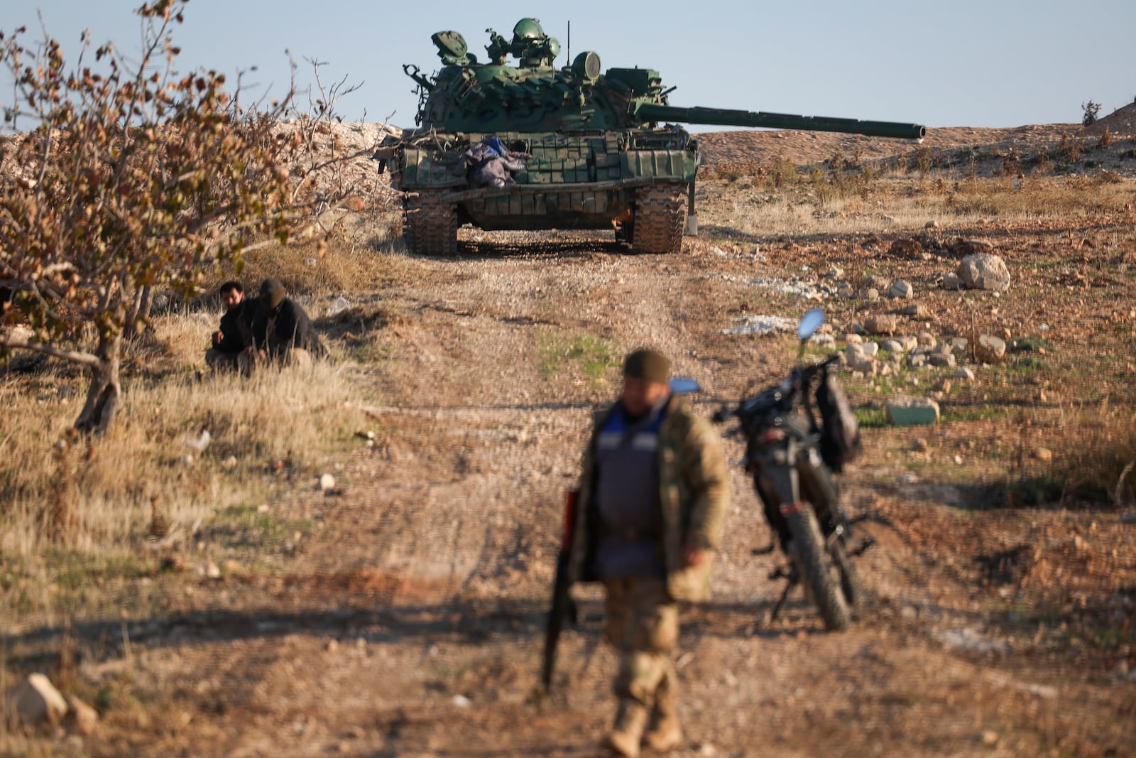 An abandoned Syrian army armoured vehicle sits on a field controlled by Syrian insurgents in the outskirts of Hama, Syria, Tuesday Dec. 3, 2024.(AP Photo/Ghaith Alsayed)