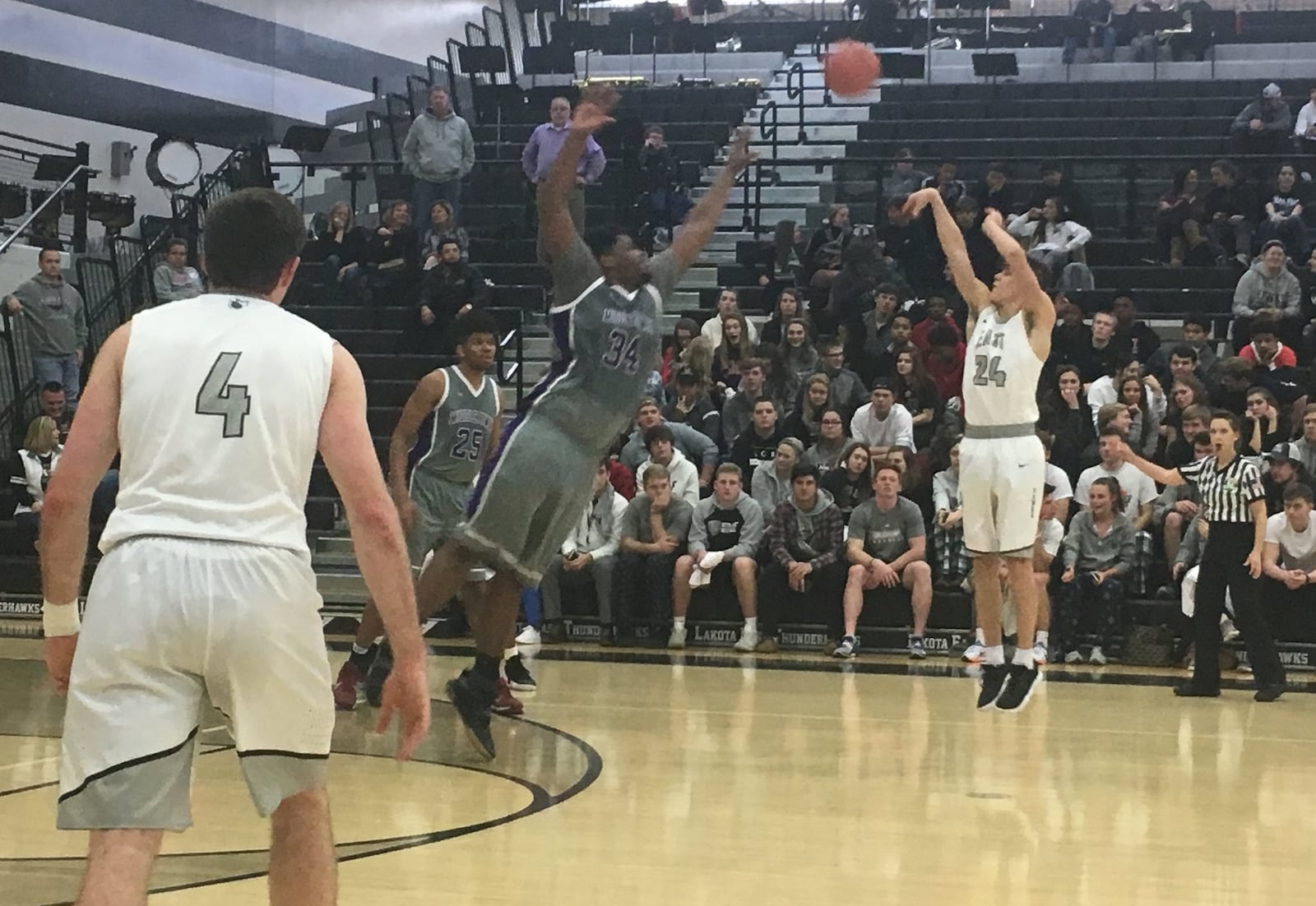 Middletown’s E.J. Williams (34) goes after a shot by Lakota East’s Will Johnston (24) during Tuesday night’s game in Liberty Township. RICK CASSANO/STAFF