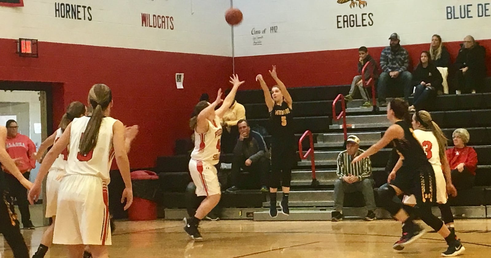 Monroe’s Sam Schwab (5) launches a shot over Preble Shawnee’s Shelbie Brown (42) during Saturday afternoon’s game at Shawnee. RICK CASSANO/STAFF