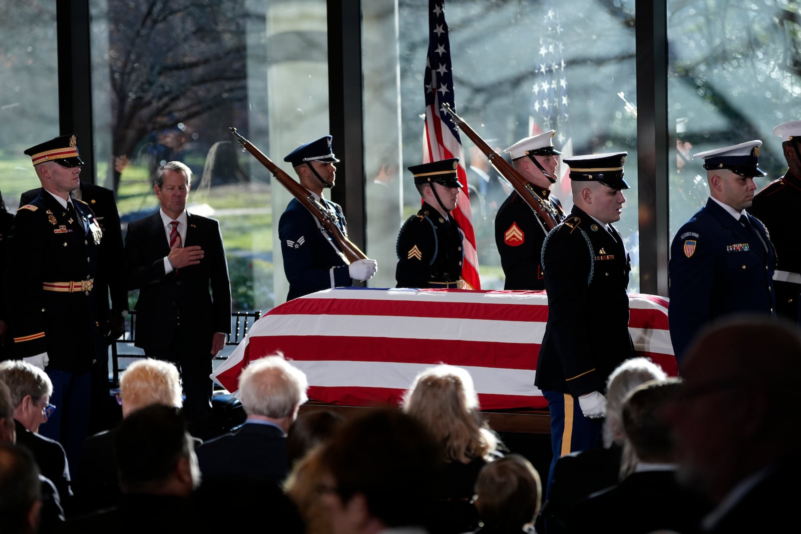 A military body bear teams places the flag-draped casket of former President Jimmy Carter onto the catafalque at the Jimmy Carter Presidential Library and Museum in Atlanta, Saturday, Jan. 4, 2025. Carter died Dec. 29 at the age of 100. (AP Photo/Alex Brandon, Pool)