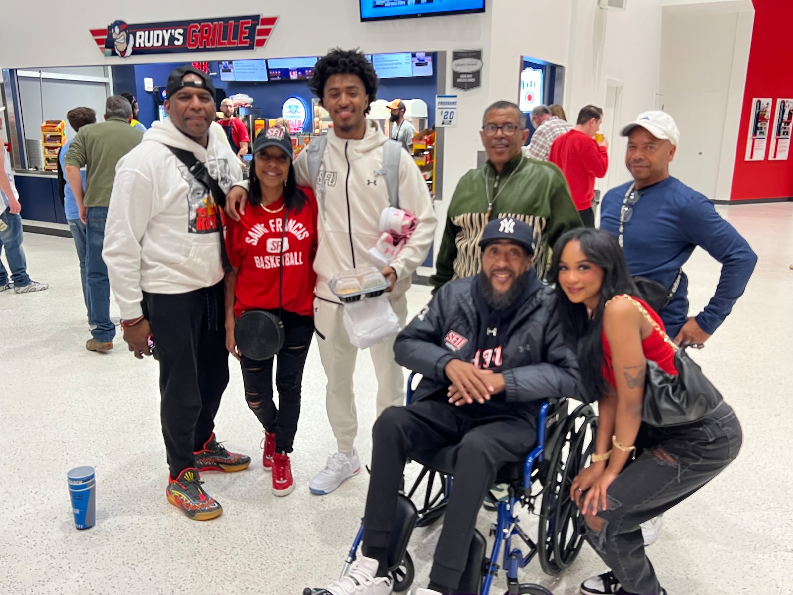 Saint Francis junior guard K.J. Swain pictured with family after his game against Alabama State in the NCAA Tournament's First Four on Tuesday night at UD Arena. Chris Vogt/CONTRIBUTED