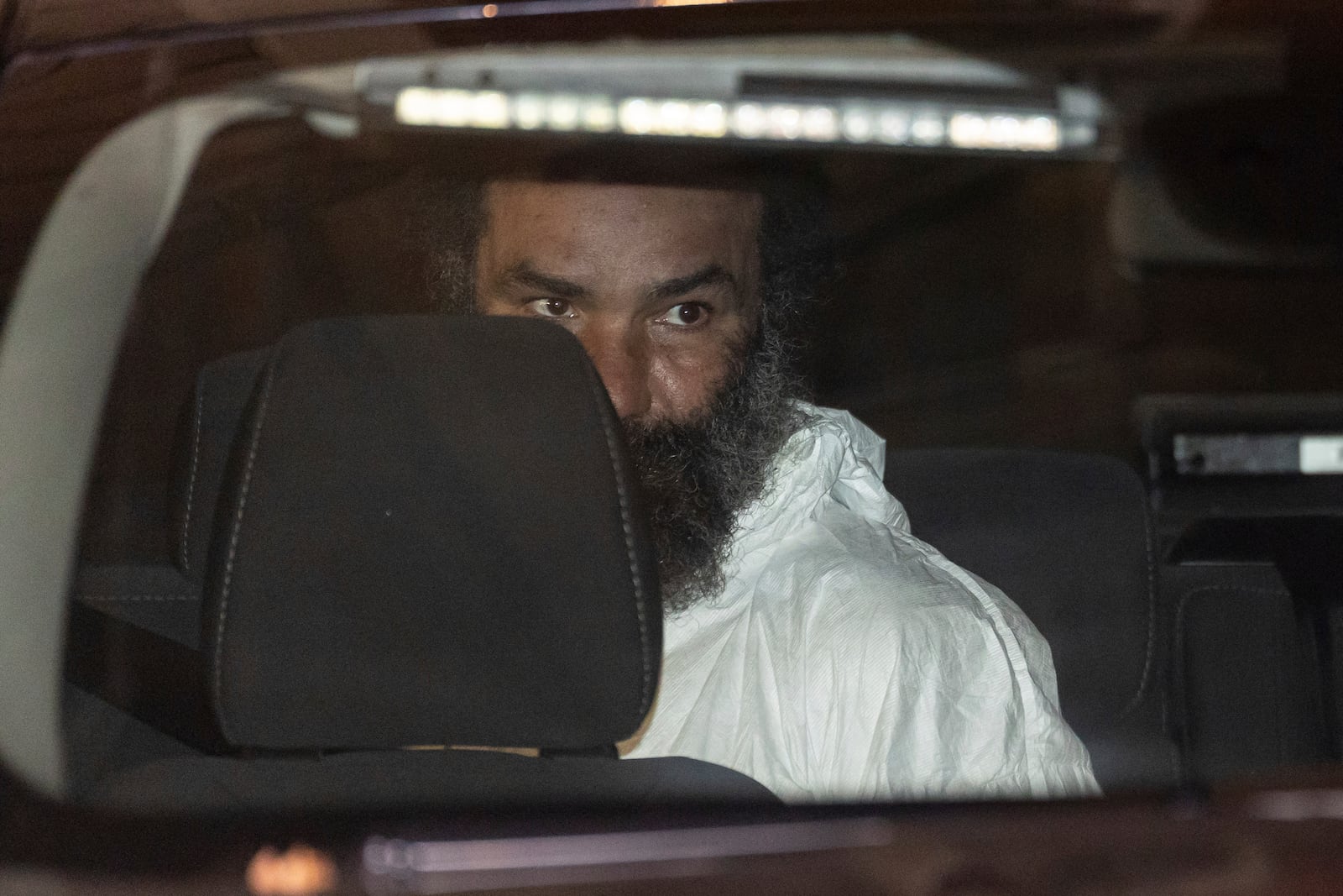 Ramon Rivera, a suspect arrested after multiple people were stabbed early Monday, is escorted out by NYPD officers at the NYPD 10th Precinct in New York, Monday, Nov. 18, 2024. (AP Photo/Yuki Iwamura)