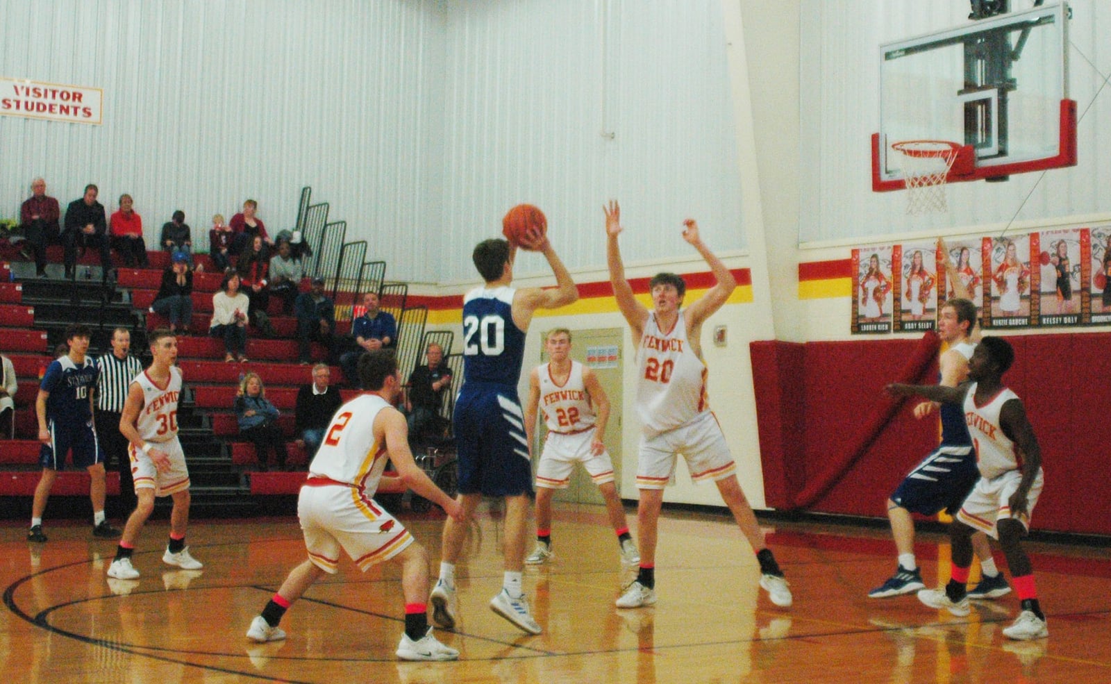 St. Xavier’s Hank Thomas (20) shoots between Fenwick’s Jared Morris (2) and A.J. Braun (20) during Saturday night’s game in Middletown. Host Fenwick won 58-53. RICK CASSANO/STAFF