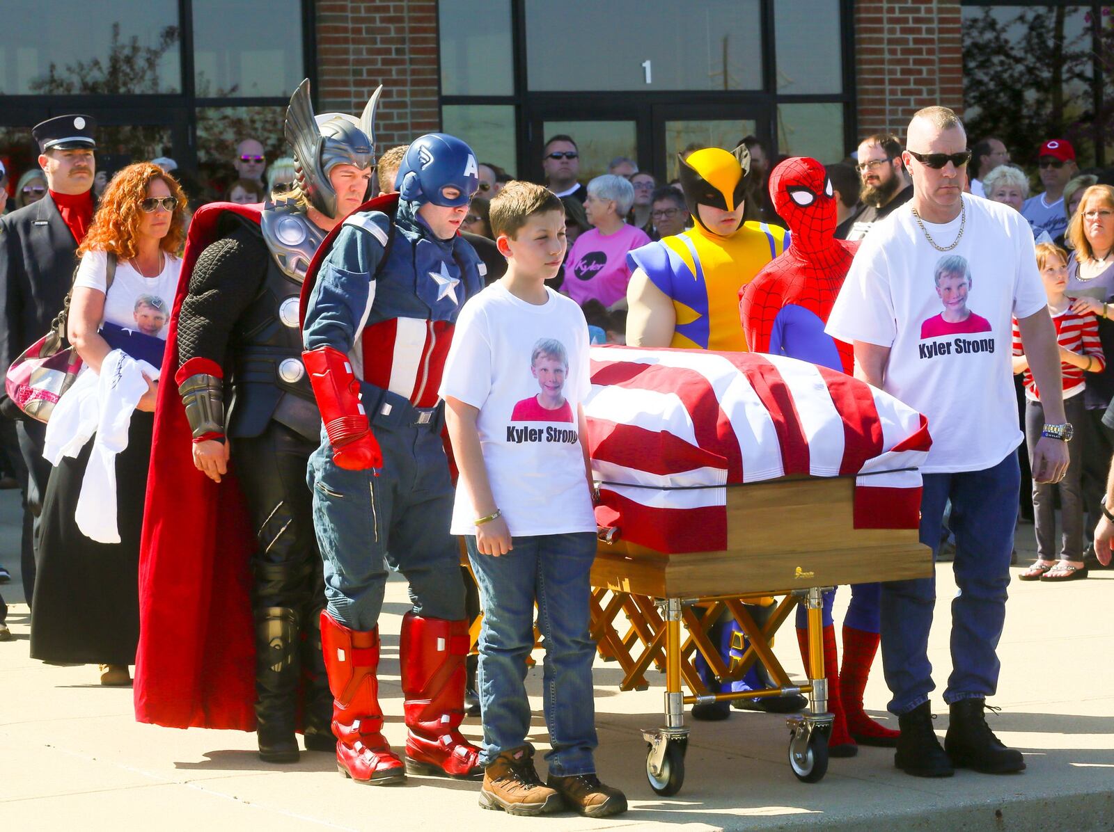 Kirk Bradley, and his son Kirk, along with a cast of superheroes carry the casket of Kyler Bradley, 10, during his funeral service at Princeton Pike Church of God, Saturday, April 16. Kyler died from DIPG, an inoperable brain cancer. GREG LYNCH / STAFF