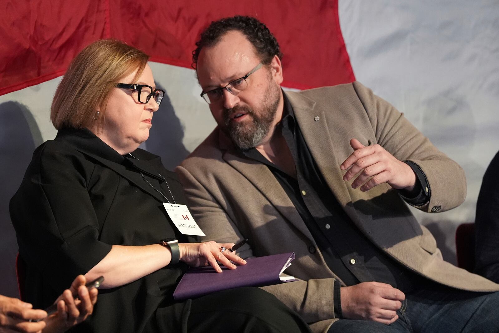 Unifor President Lana Payne and Flavio Volpe, head of the Automotive Parts Manufacturers' Association, talk before the start of a Canada-U.S. economic summit in Toronto, Friday, Feb. 7, 2025. (Frank Gunn /The Canadian Press via AP)