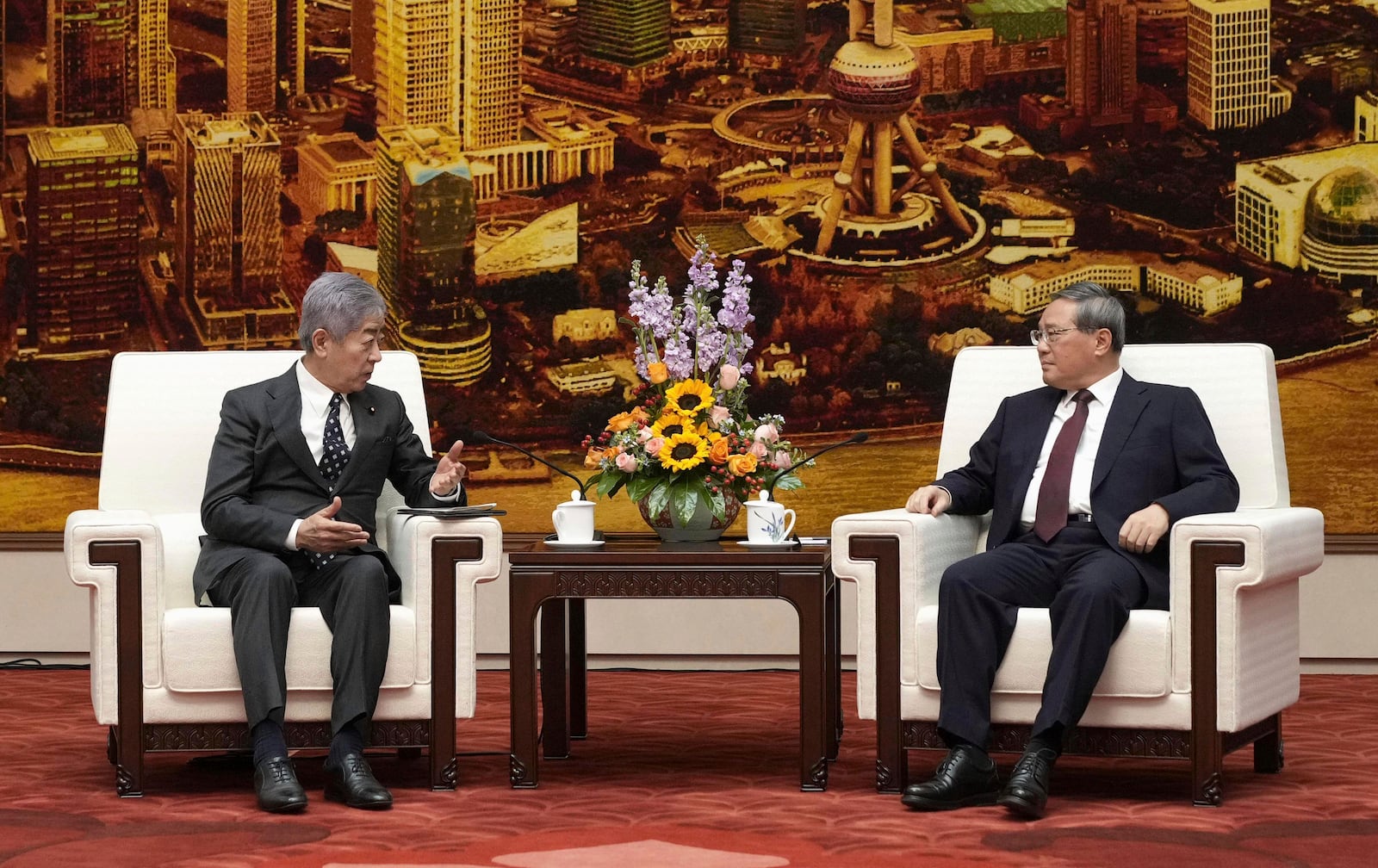 FILE - Japan's Foreign Minister Takeshi Iwaya, left, and Chinese Premier Li Qiang, right, hold a talk at the Great Hall of the People in Beijing on Dec. 25, 2024. (Kyodo News via AP, File)