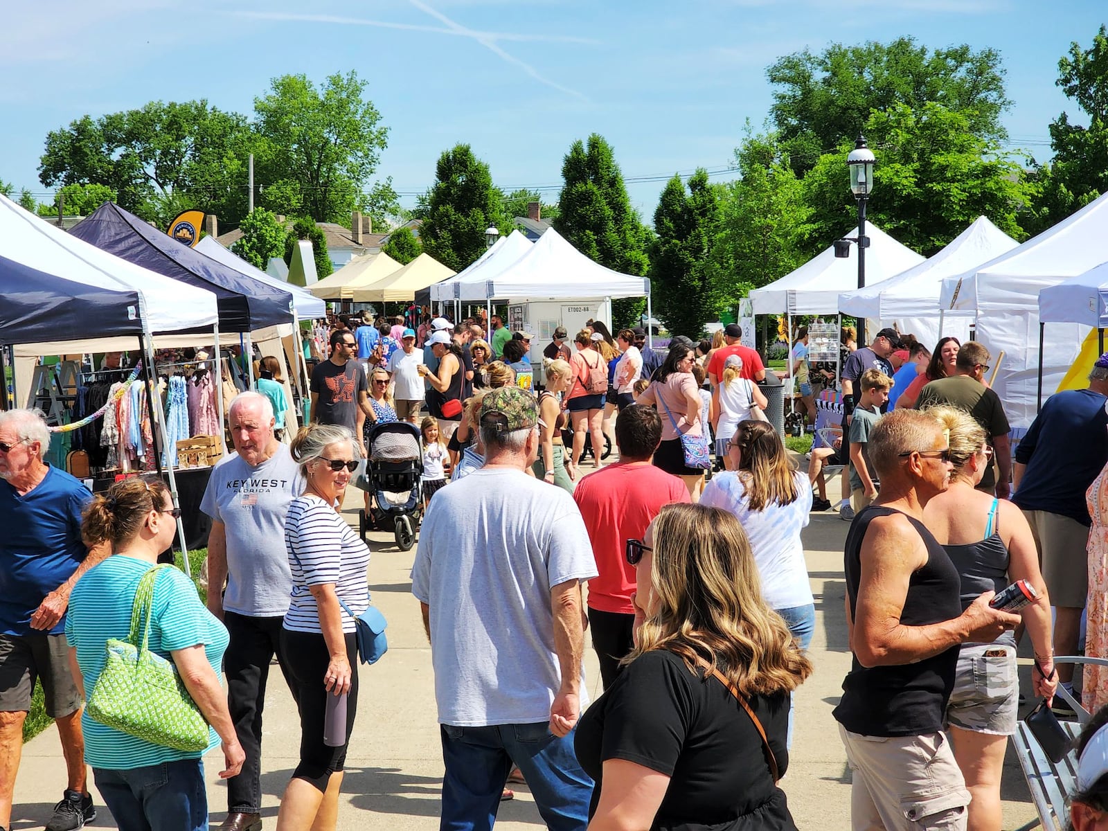 Visitors stroll through Hamilton Flea, a monthly urban artisan market, Saturday, May 14, 2022 at Marcum Park in Hamilton. NICK GRAHAM/STAFF