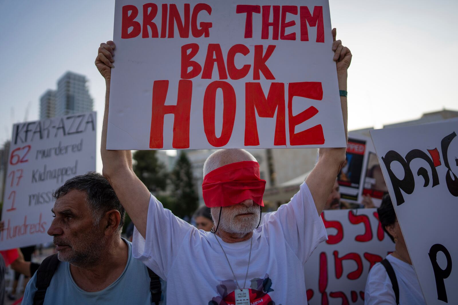 FILE - Residents of Kibbutz Kfar Azza wear blindfolds during a demonstration in solidarity with friends and relatives being held hostage in the Gaza Strip, in Tel Aviv, Israel, on Nov. 2, 2023. (AP Photo/Oded Balilty, File)