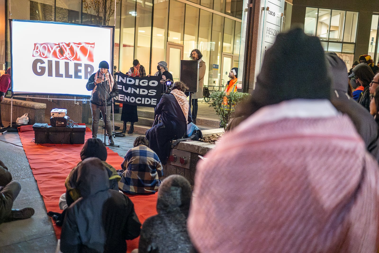 Demonstrators gather in front of a downtown Toronto hotel for the Giller Award ceremony, chanting "free Palestine" and holding banners, in Toronto, Monday, Nov. 18, 2024. (Eduardo Lima/The Canadian Press via AP)